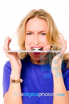 Woman Biting Digital Tablet Stock Photo