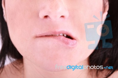 Woman Biting On Her Lip Stock Photo