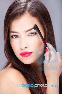 Woman Combing Eyebrow Stock Photo