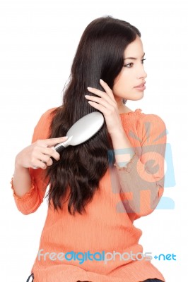 Woman Combing Her Hair Stock Photo