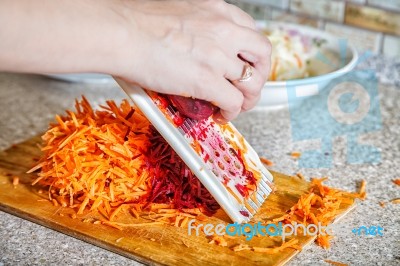 Woman Cooks The Beets On A Grater Stock Photo