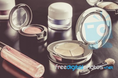 Woman Cosmetic Foundation And Eyeshadow And Lip Gloss And Brush Stock Photo