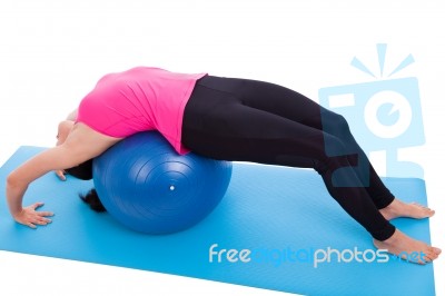 Woman Doing Yoga,  Lies On Gym Ball. Isolated On White. Studio Shot Stock Photo