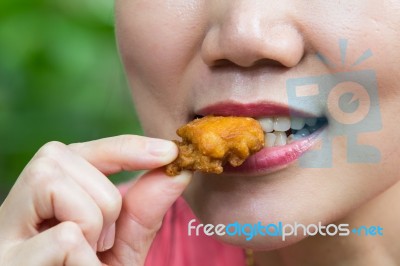 Woman Eating Chicken Stock Photo