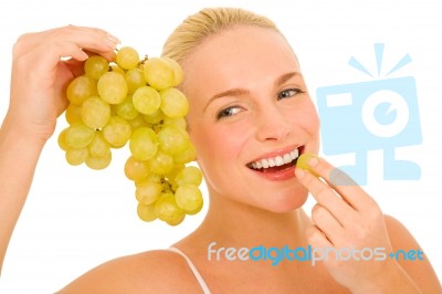 Woman Eating Grapes Stock Photo