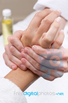 Woman Enjoying Hand Massage At Beauty Spa Stock Photo