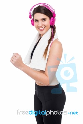 Woman Enjoying Music While Jogging Stock Photo