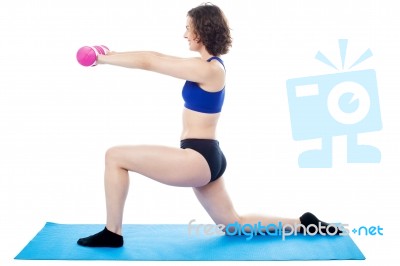 Woman Exercising With Dumbbells, Arms Outstretched Stock Photo