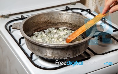 Woman Frying Onions Stock Photo