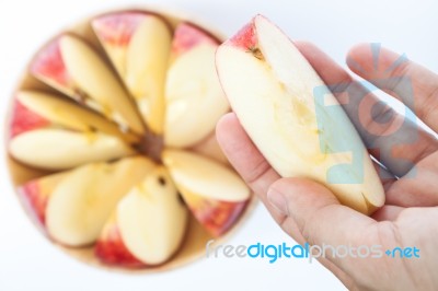 Woman Hand Holding Piece Of Apple Stock Photo