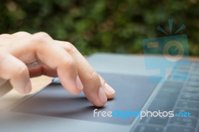 Woman Hand Using Laptop Touchpad Stock Photo