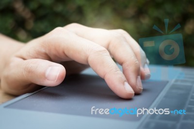 Woman Hand Using Laptop Touchpad Stock Photo