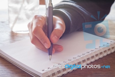 Woman Hand With Pen Writing On Notebook Stock Photo