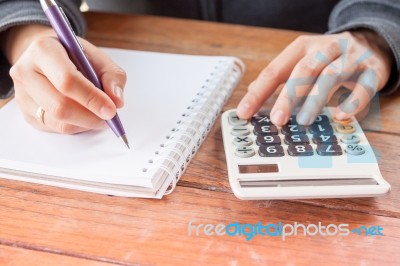 Woman Hand With Pen Writing On Notebook Stock Photo