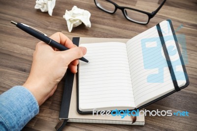 Woman Hand Writing On Notebook Stock Photo