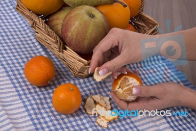 Woman Hands Peeling A Mandarin Stock Photo
