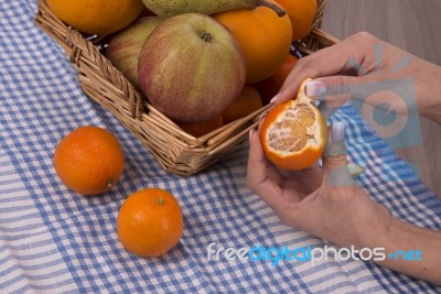 Woman Hands Peeling A Mandarin Stock Photo