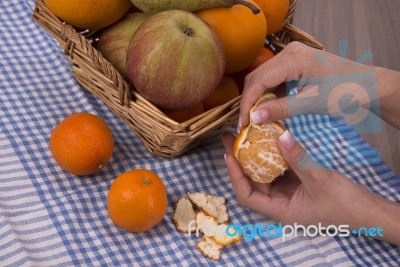 Woman Hands Peeling A Mandarin Stock Photo