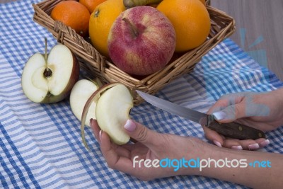 Woman Hands Peeling An Apple With A Knife Stock Photo