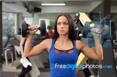 Woman Holding A Hand Weight Stock Photo