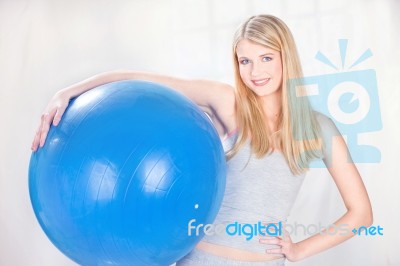 Woman Holding Blue Pilates Ball Stock Photo