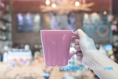 Woman Holding Coffee Mug With Blurred Cafe Background Stock Photo
