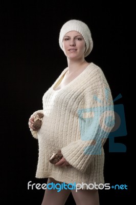 Woman Holding Her Pregnant Belly. Black Background Stock Photo