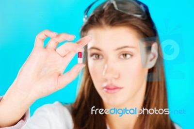 Woman Holding Red Pill Stock Photo