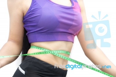 Woman In Sport Bra Measuring Her Body With Tape Isolated On Whit… Stock Photo