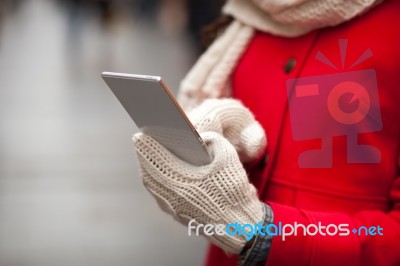 Woman In Wool Gloves Hold Smart-phone Stock Photo