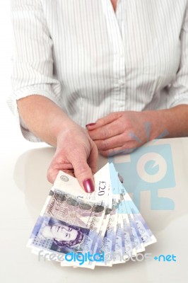 Woman Is Paying In British Currency Stock Photo