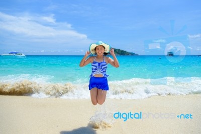 Woman Jumping With Happy On The Beach At Thailand Stock Photo