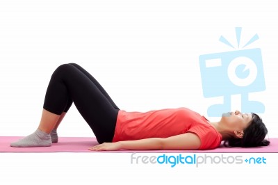 Woman Laying Down And Starting Exercise Stock Photo