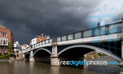 Woman Looking Over Eton Bridge As A Storm Approaches Stock Photo