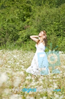 Woman looking up In Meadow Stock Photo