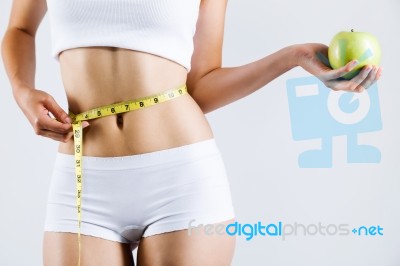 Woman Measuring Her Slim Body. Isolated On White Background Stock Photo