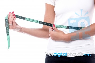 Woman Measuring Waist With An Inch Tape Stock Photo