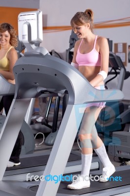 Woman On Running Machine In Gym Stock Photo
