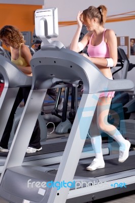 Woman On Running Machine In Gym Stock Photo