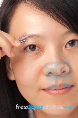 Woman Plucking Eyebrows Stock Photo