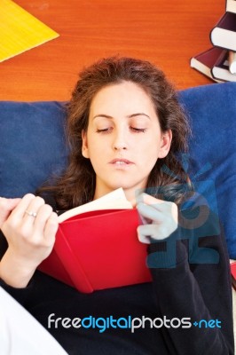 Woman Reading Book At Home Stock Photo