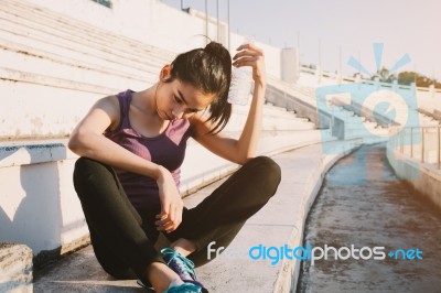 Woman Relaxing After Sports And Drinking Water Stock Photo