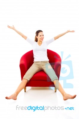 Woman Sat On Armchair Stock Photo