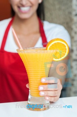 Woman Serving Fresh Orange Juice Stock Photo