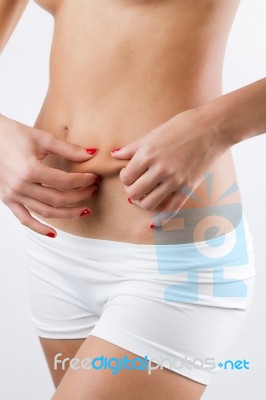 Woman Showing Cellulite On Her Belly Stock Photo