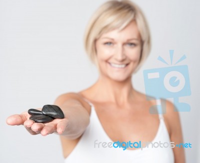 Woman Showing Polished Spa Stones Stock Photo