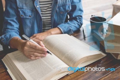 Woman Sitting In A Cafe, Reading Book Stock Photo