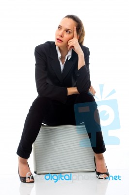 Woman Sitting On Briefcase Stock Photo