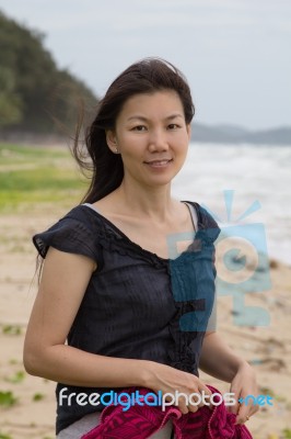 Woman Smiling On A Tropical Beach Stock Photo