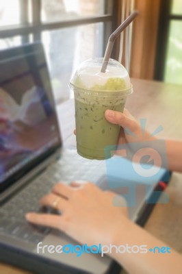 Woman Using Laptop In The Coffee Shop Stock Photo